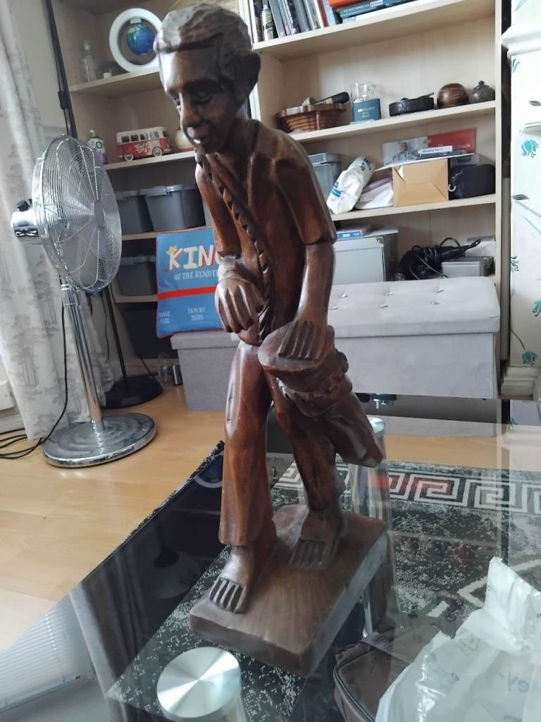 Carved man playing a drum   AFRICAN