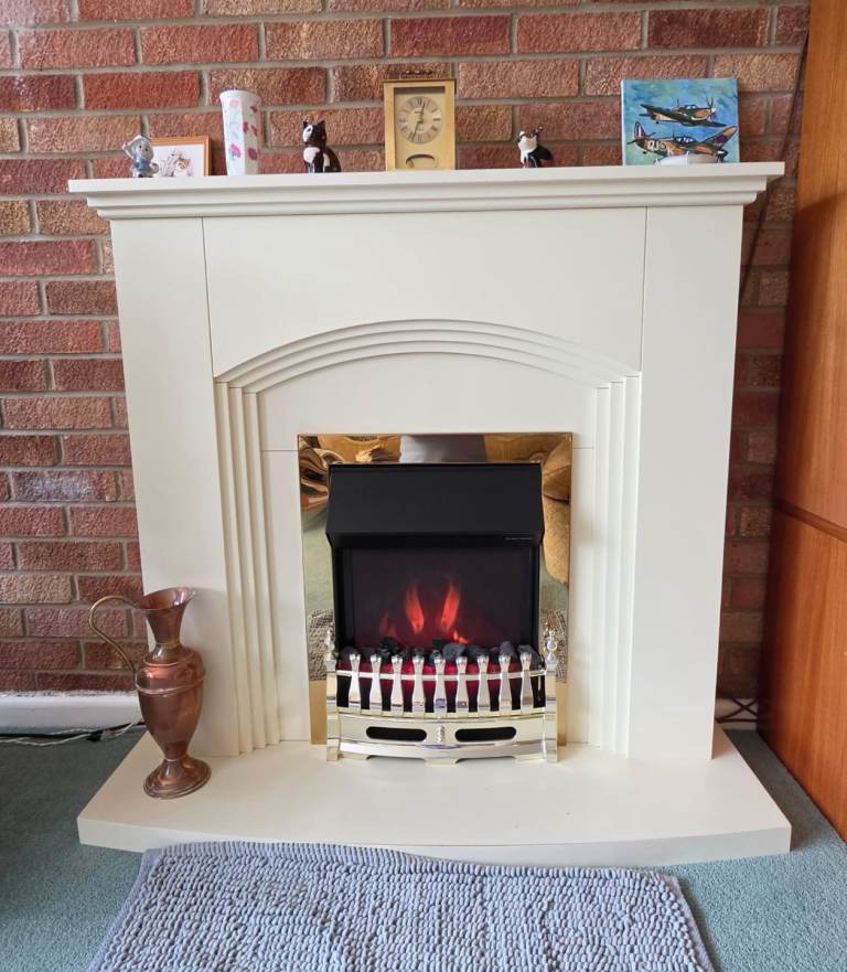 Freestanding fireplace suite with electric fire
