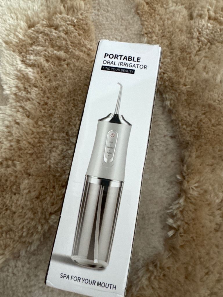 Portable oral irrigator