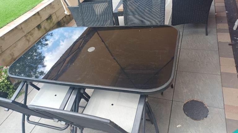 Garden Patio Table with black Glass Top & 4 folding chairs– Good Condition