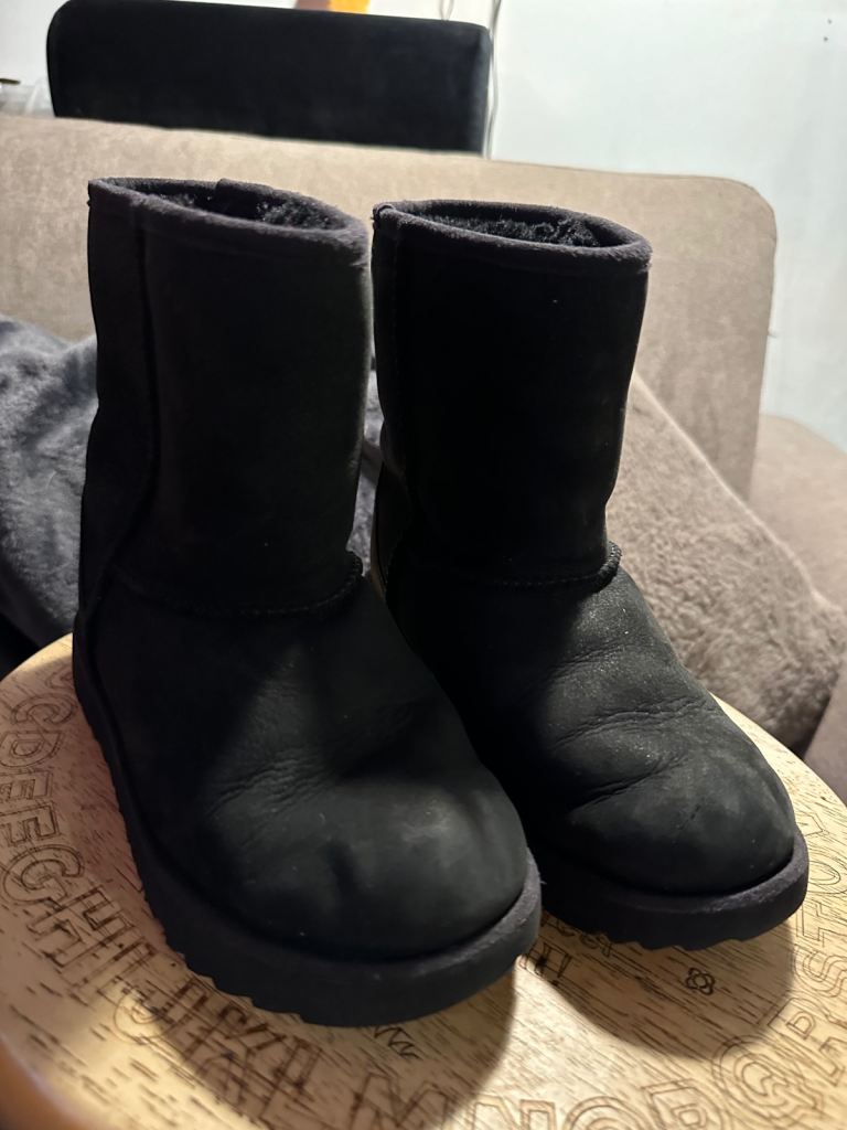 Girls black UGG boots.