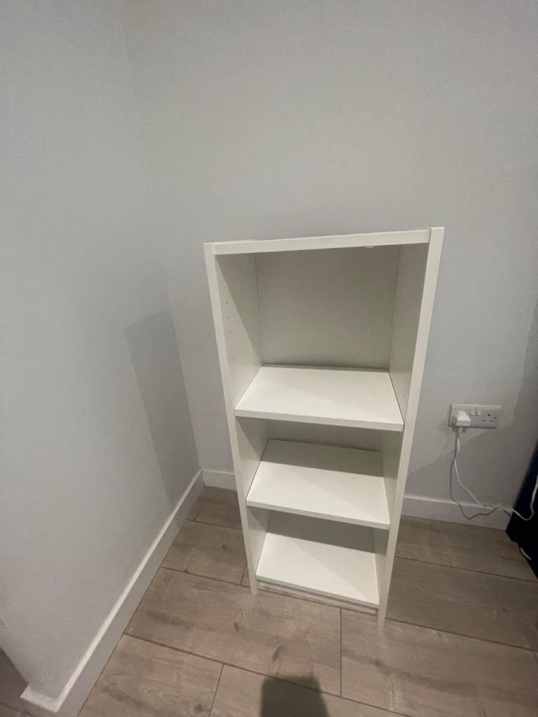  A white shelving unit and a full-length standing mirror