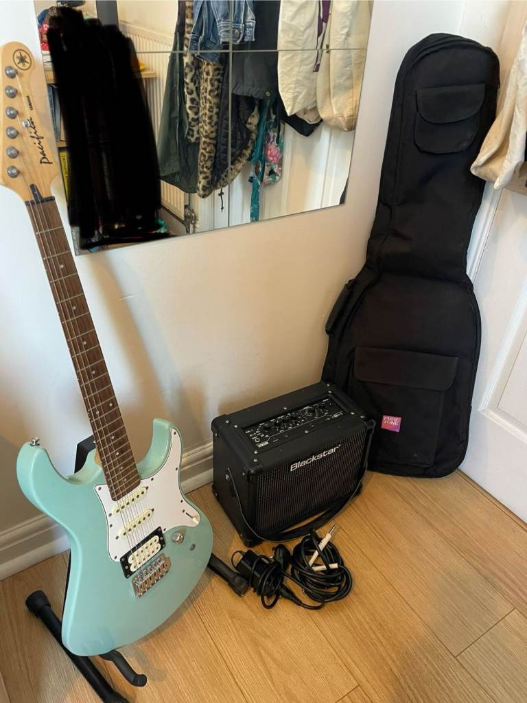 Baby blue Pacifica Yamaha electric guitar with Blackstar amp, guitar bag, guitar stand and cables.