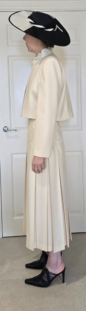 Helen Sykes cream suit, black satin camisole and black/cream hat