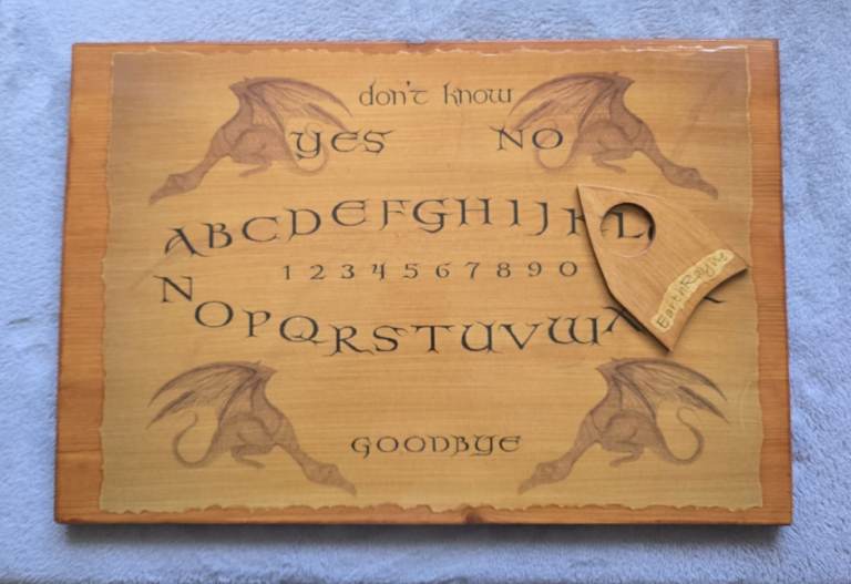 Wooden Ouija board. Spirit board with pointer. ghost, messages, spirituality