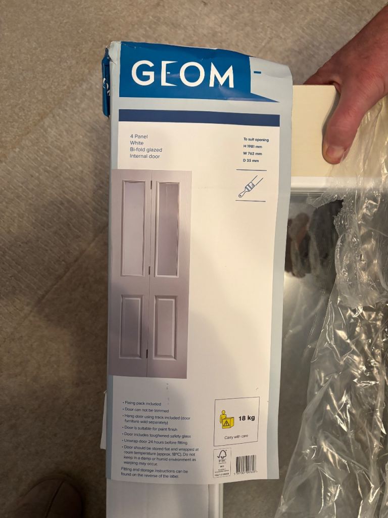 Unused White bi-fold half glazed door. (1 Trim damaged ) 