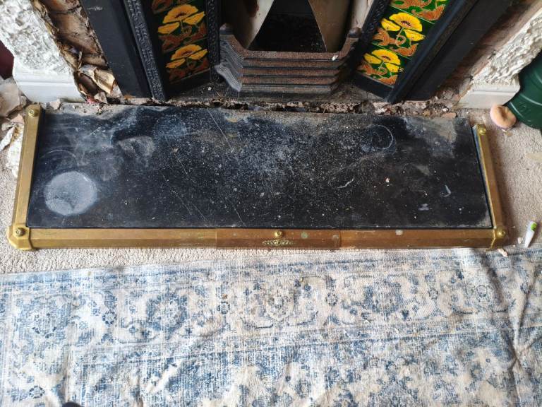 Marble hearth with brass surround