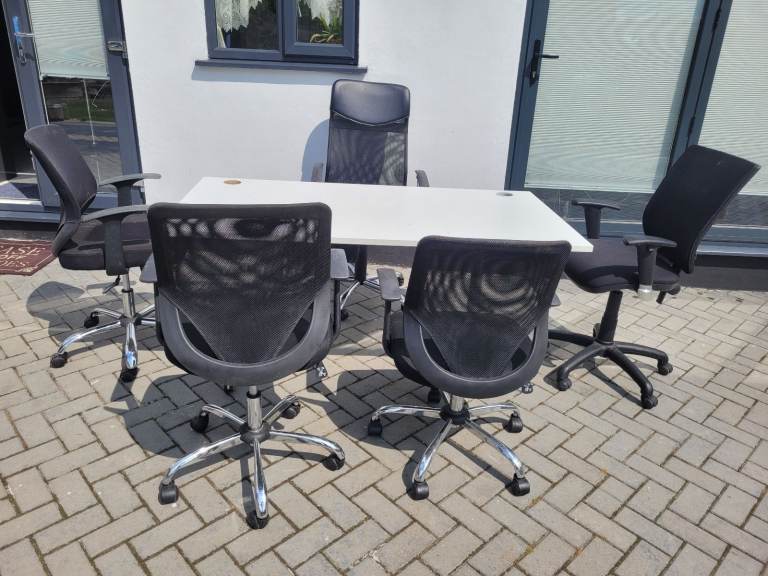 Black leather office chairs and whiteto office tables