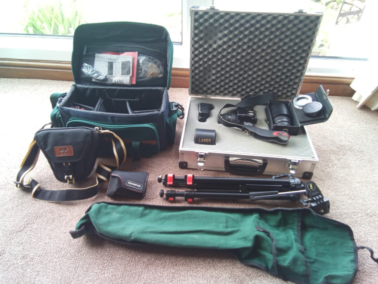 Canon Eos 1000F film camera with additional lenses and other accessories.