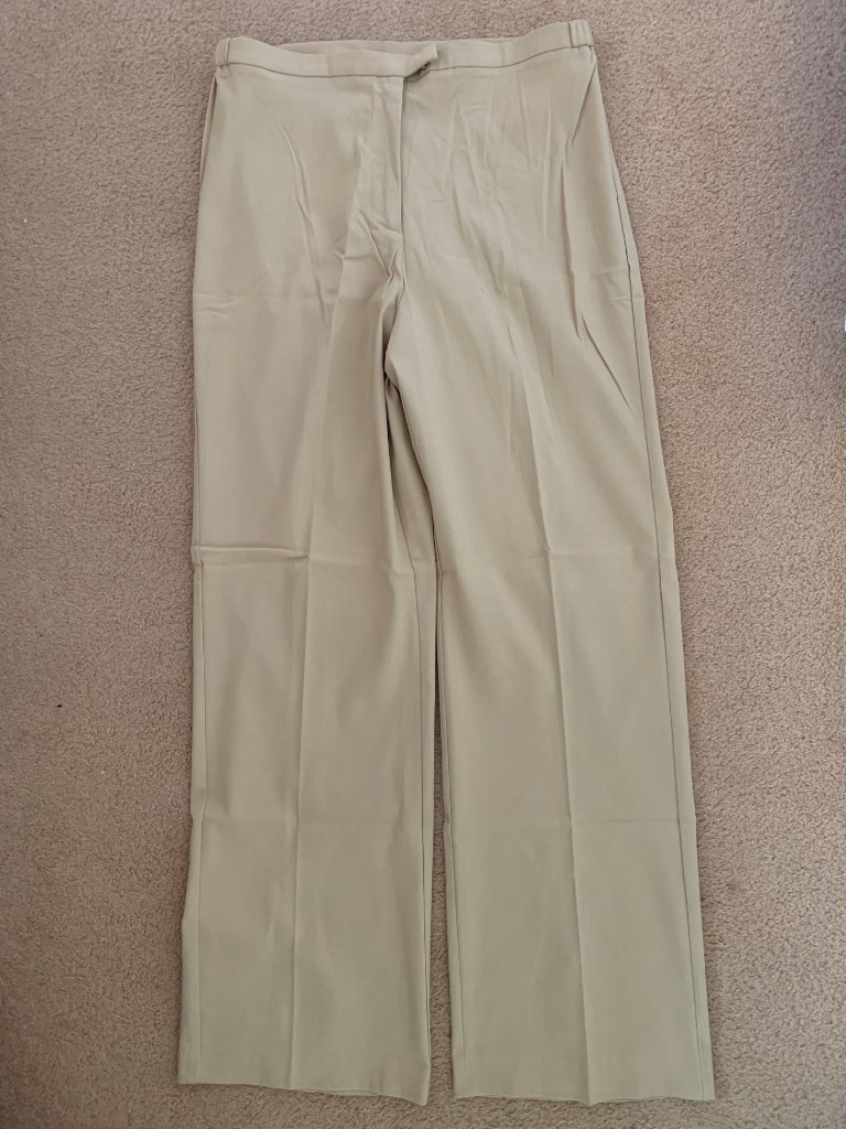 Camera women stretch beige colour trousers.
