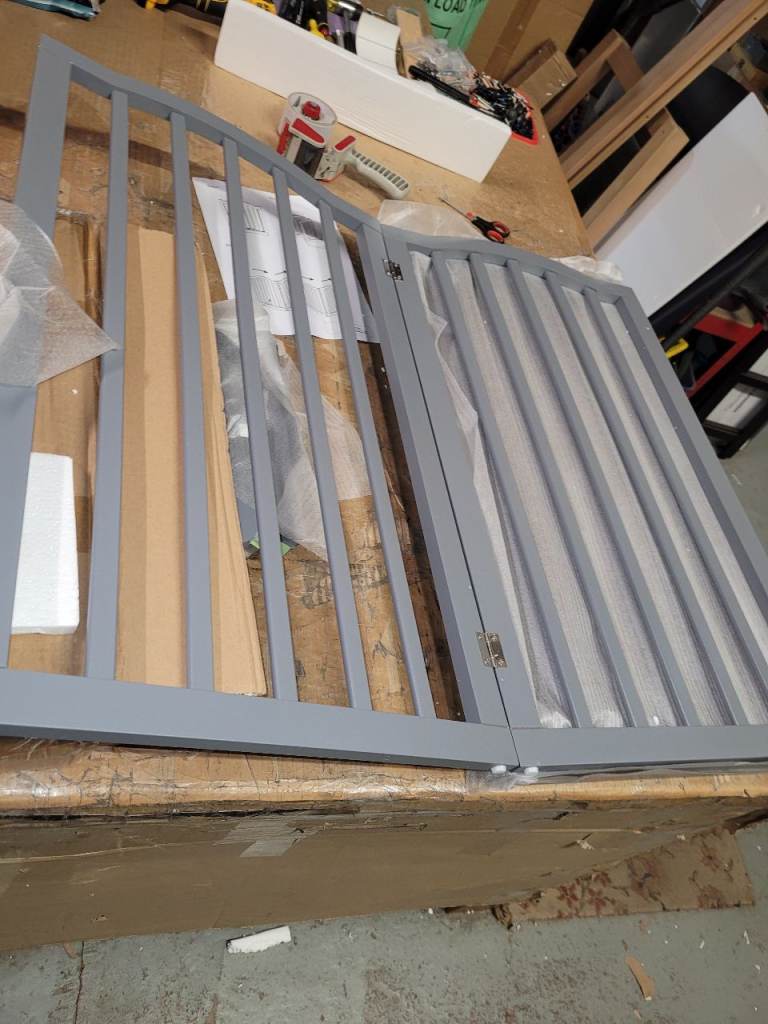 A new still boxed wooden grey folding freestanding 4 panel pet gate with 2 