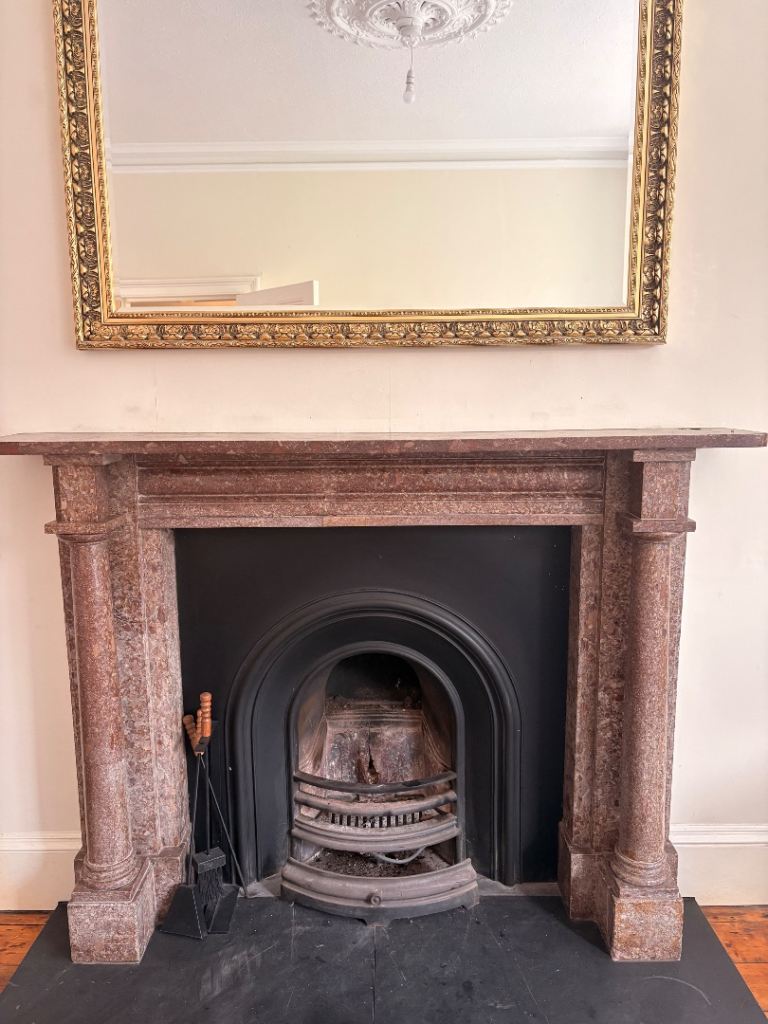 Brown marble fireplace surround 