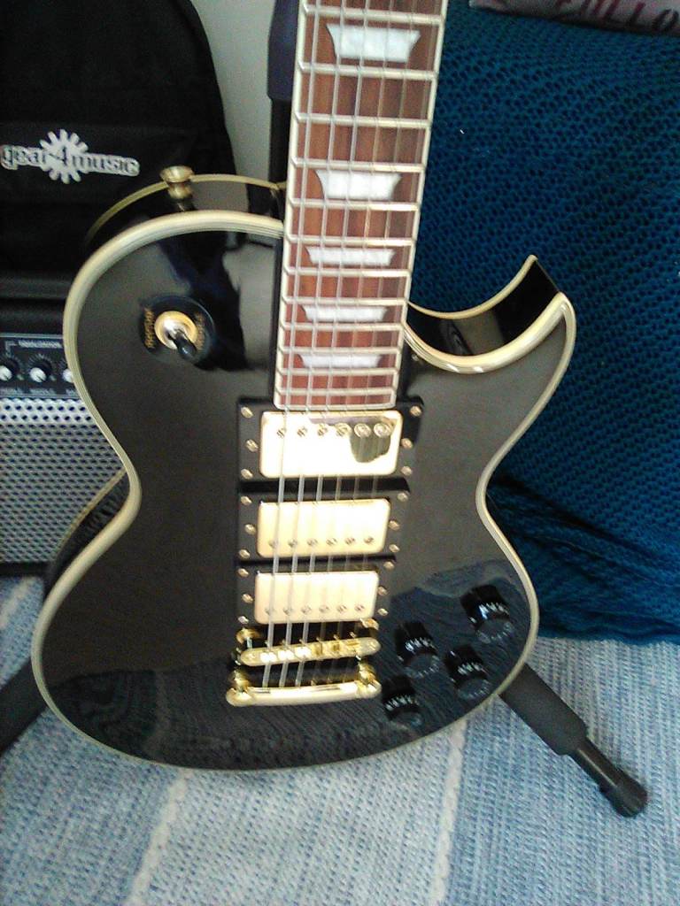 Black and gold Electric Guitar, three humbuckers,with gig bag, as new condition, £200