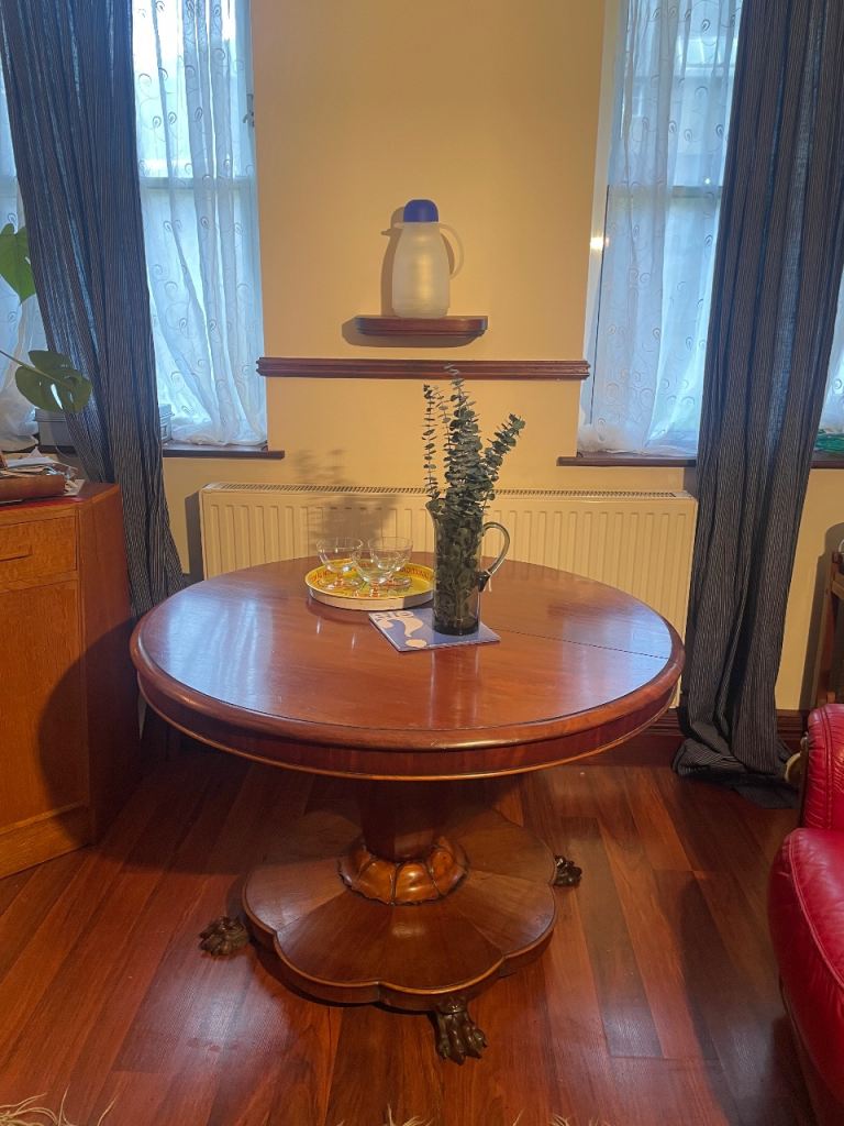 Antique tilt-top table with claw feet 