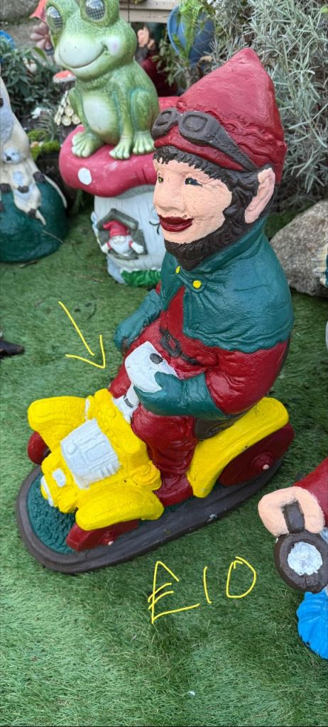 Garden statue man in a car 