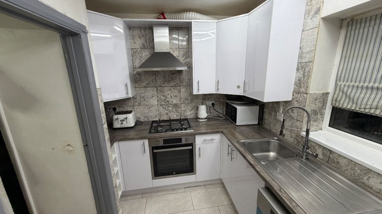 Gloss White Kitchen Cabinets and Worktop with Appliances