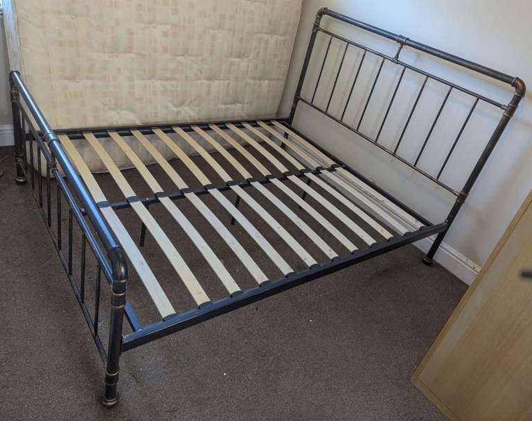 Double iron style bed with wood slats