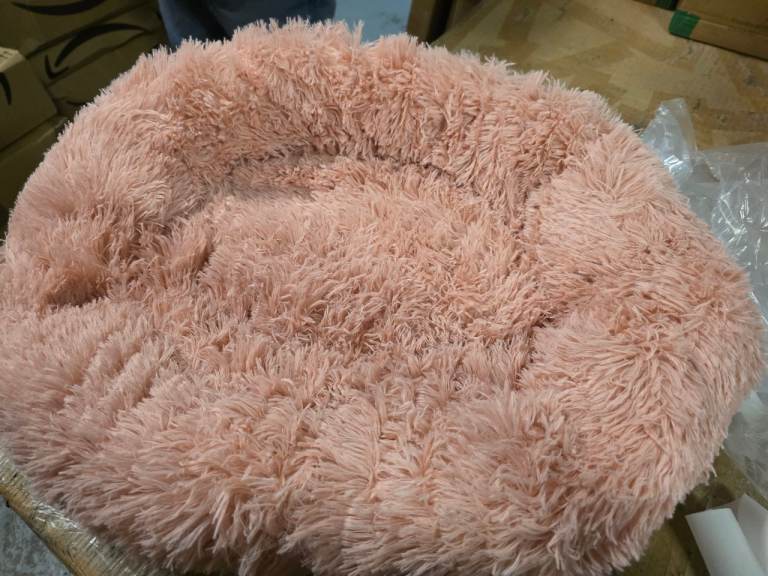 A new still packed pink fluffy 20inch pet bed with anti slip bottom. 