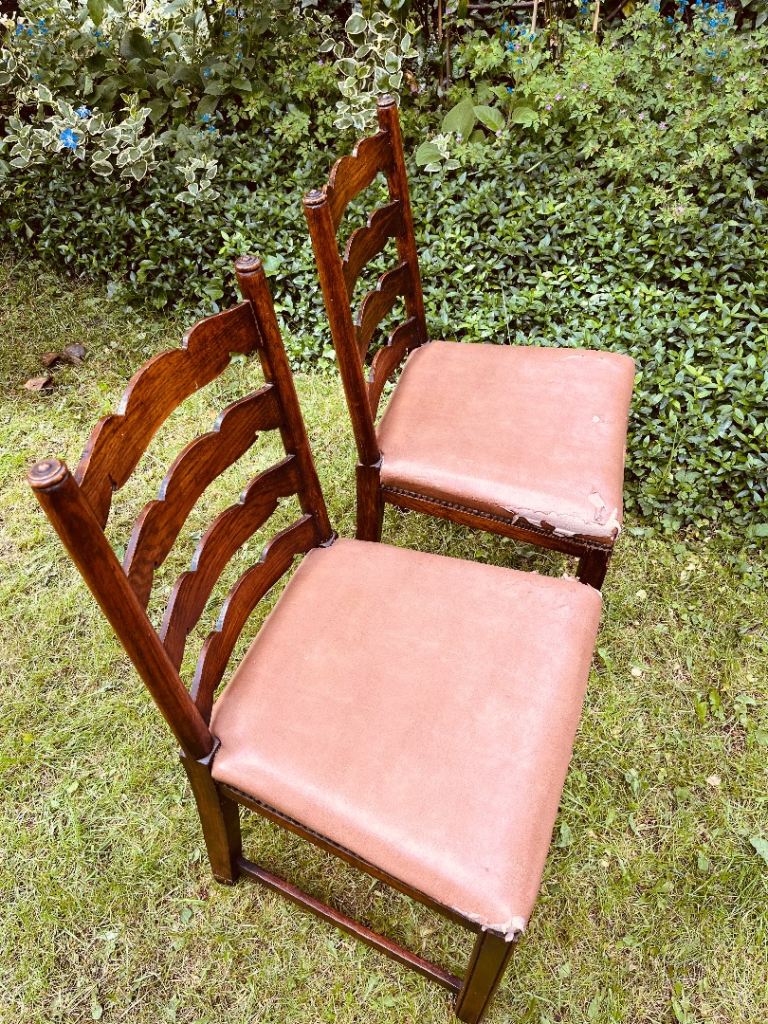 Pair of ladder back solid oak chairs with faux leather seats
