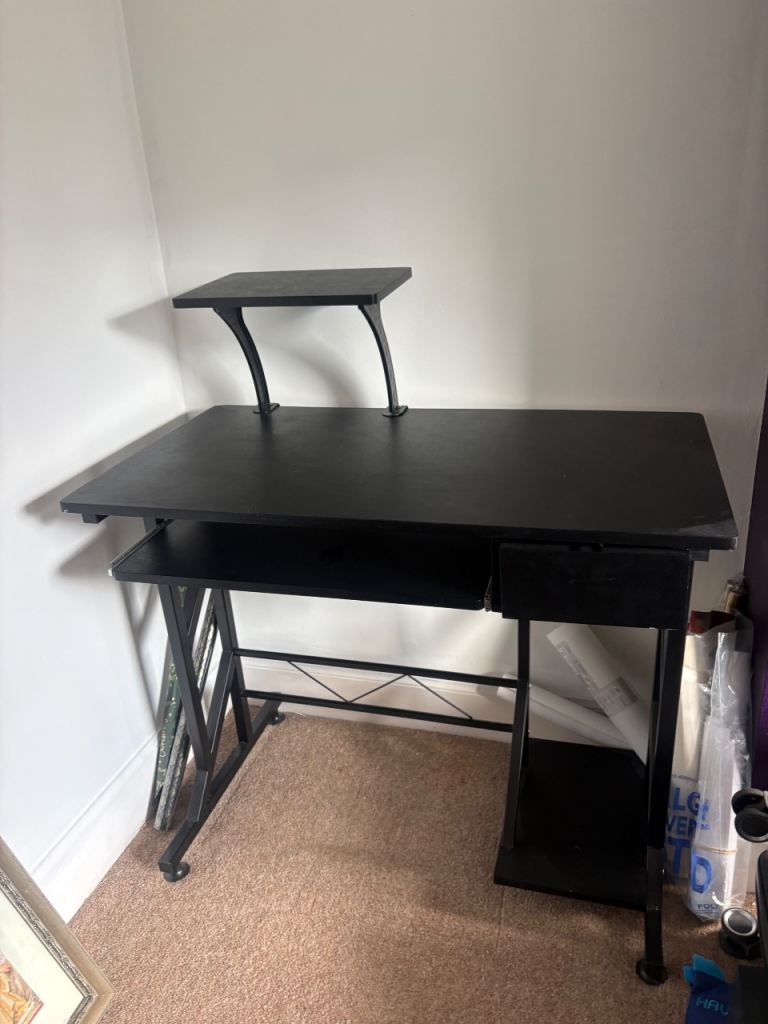 Black Homcom computer desk with elevated shelf.