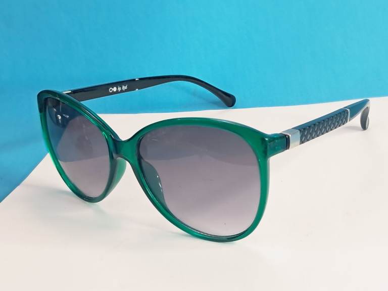 green-tinted sunglasses are branded as "by Red"