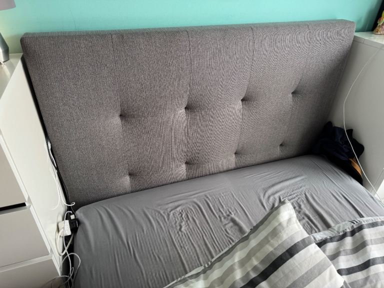 Grey fabric cushioned double ottoman bed