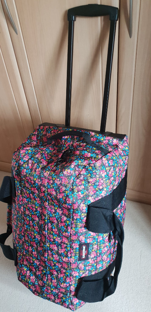 Brand new, wheeled luggage/large holdall (Eastpak), extendable handle, excellent condition.