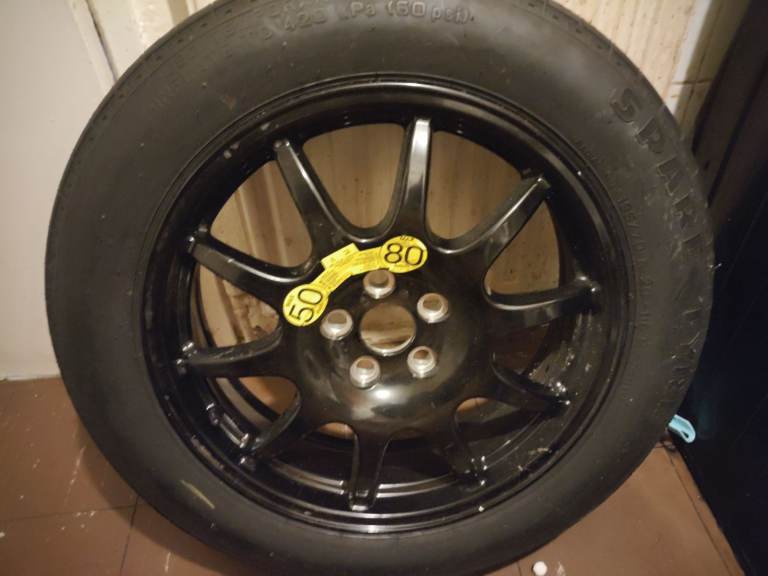 Garage full of car parts, bicycles