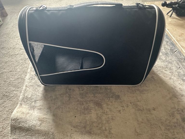 soft-sided pet carrier, commonly used for transporting cats or small dogs