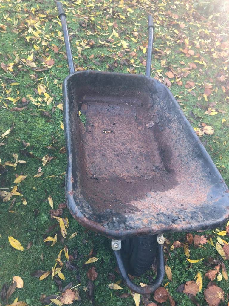image for Wheelbarrow with holes in the metal