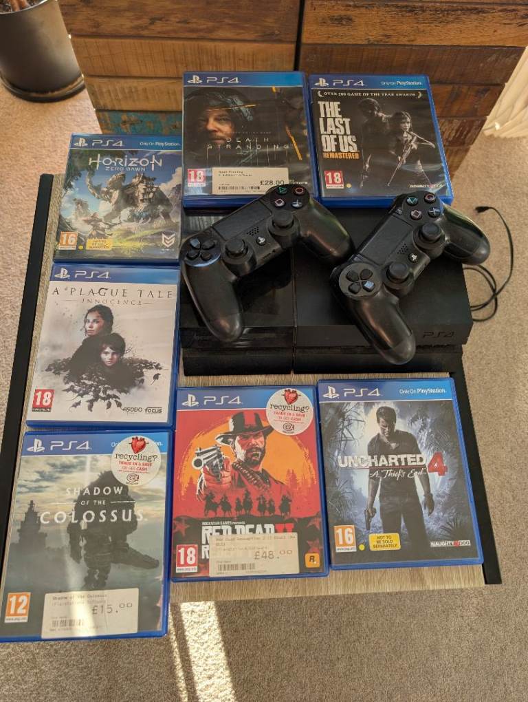 PS4 with 2 controllers and 8 games