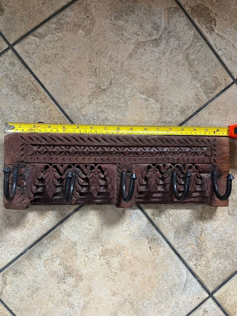 Antique teak hand-carved wooden coat and hat rack with floral carvings and five forged iron Hooks