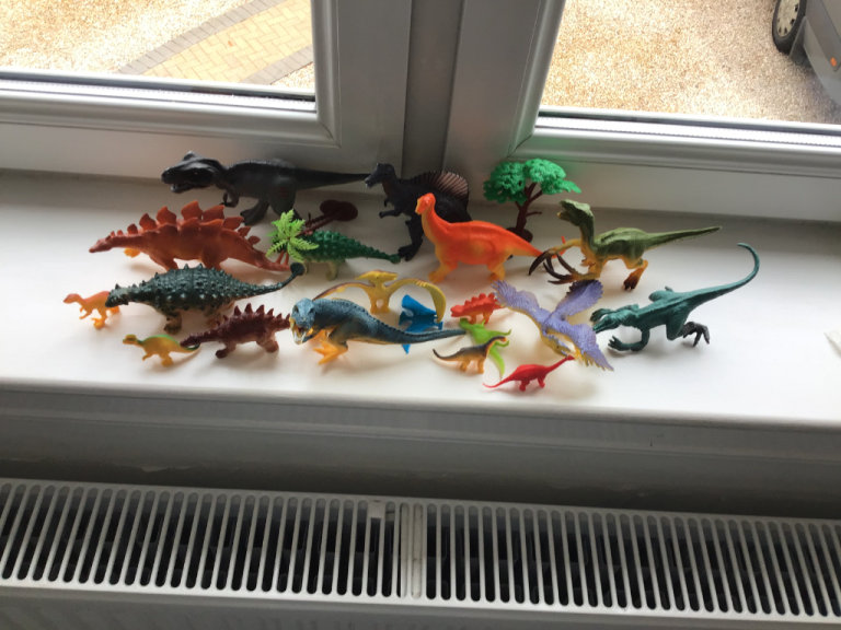 10 LARGE DINOSAURS WITH SOME SMALL ONES AND TREES.