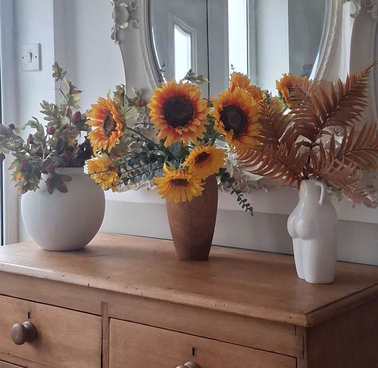 Three autumn flower arrangements with vases 