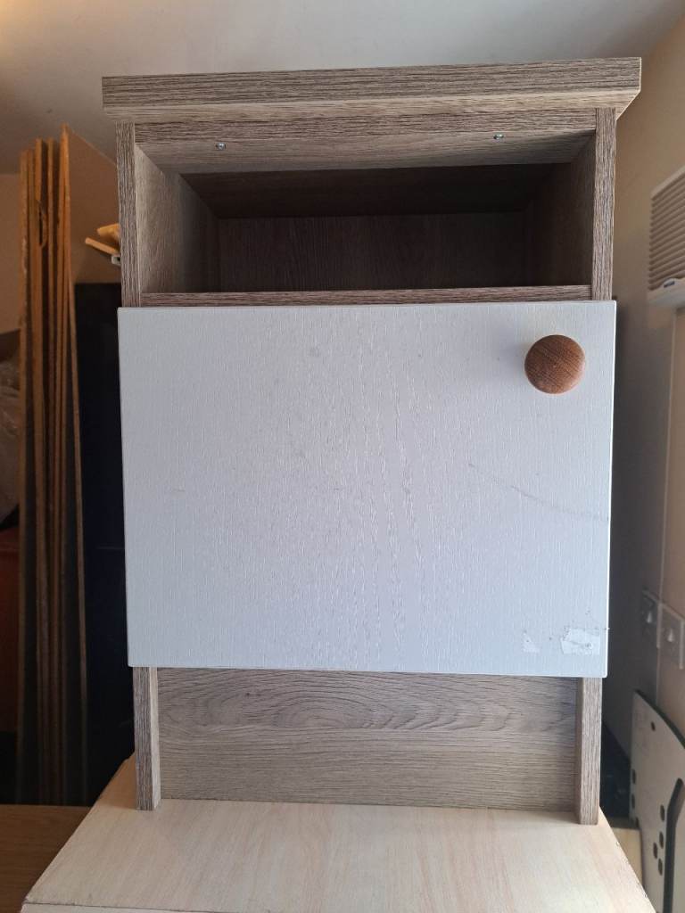 bedside cabinet with light wood frame and white door 