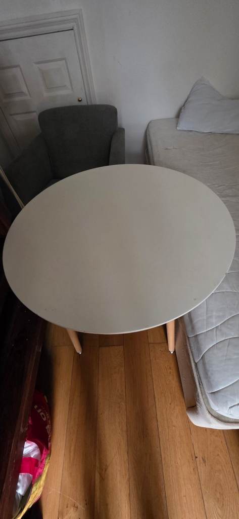 Round White Dining Table with Tapered Wooden Legs