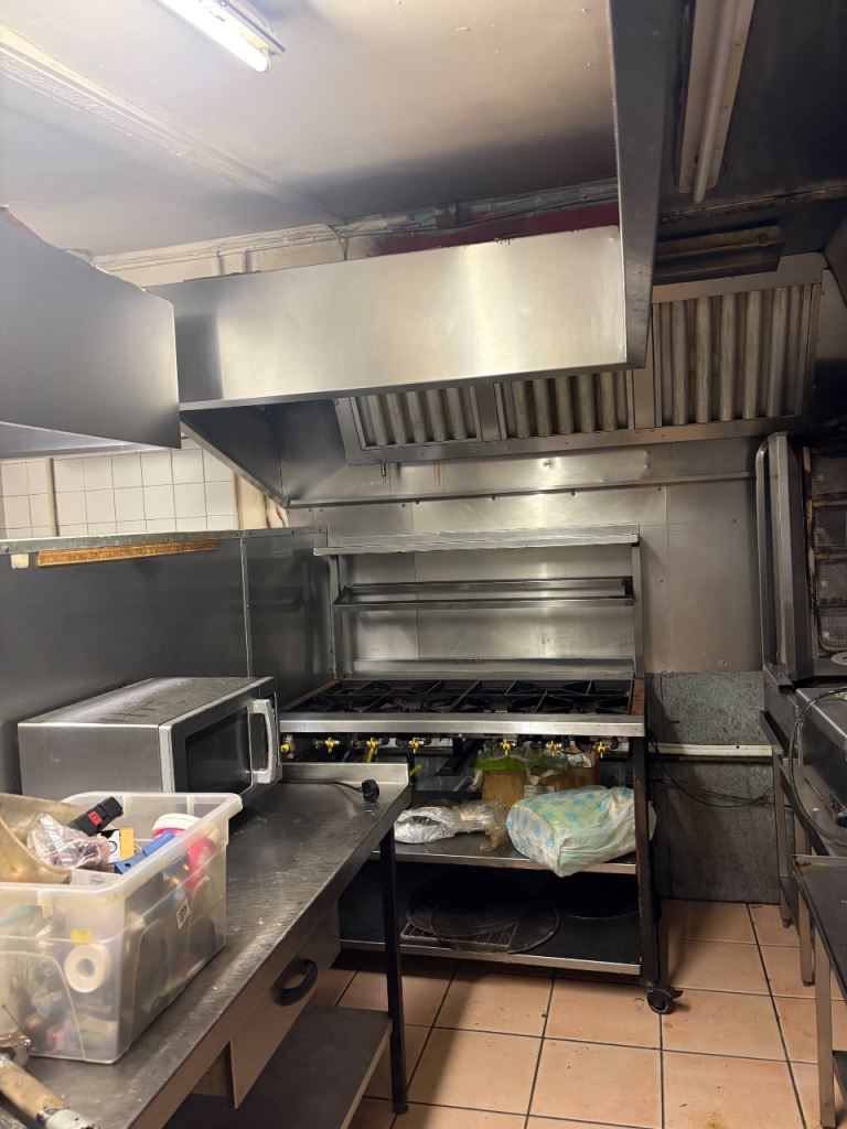 Selection of stainless commercial kitchen equipment and fridge 