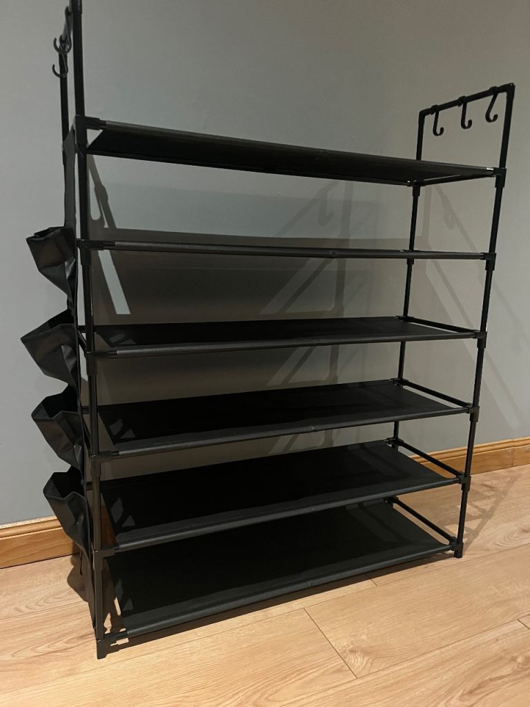6 tier lightweight shoe rack with pockets and hooks. Brand new and assembled.