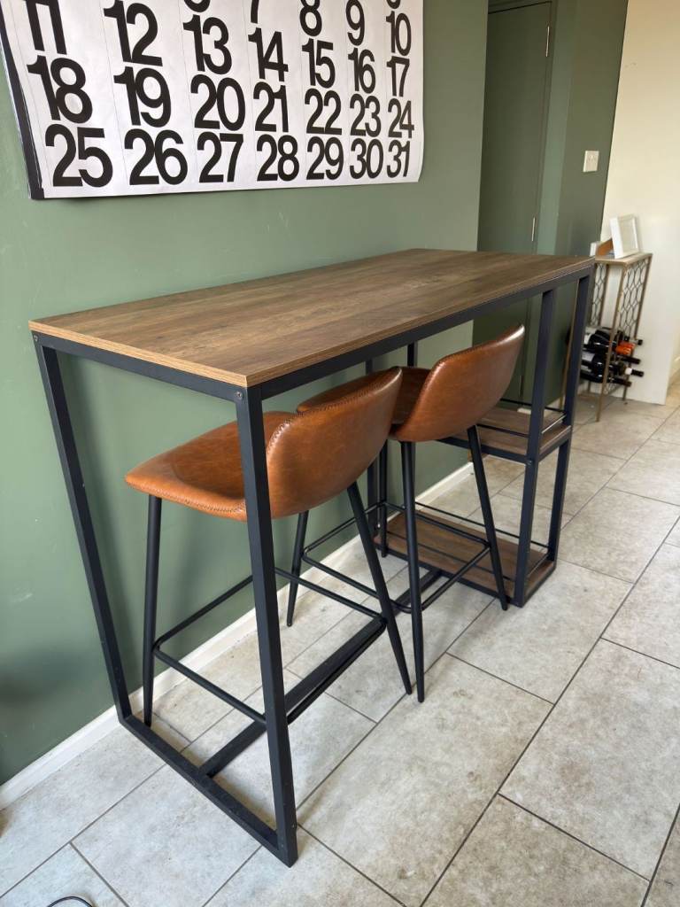 Bar table and two chairs.