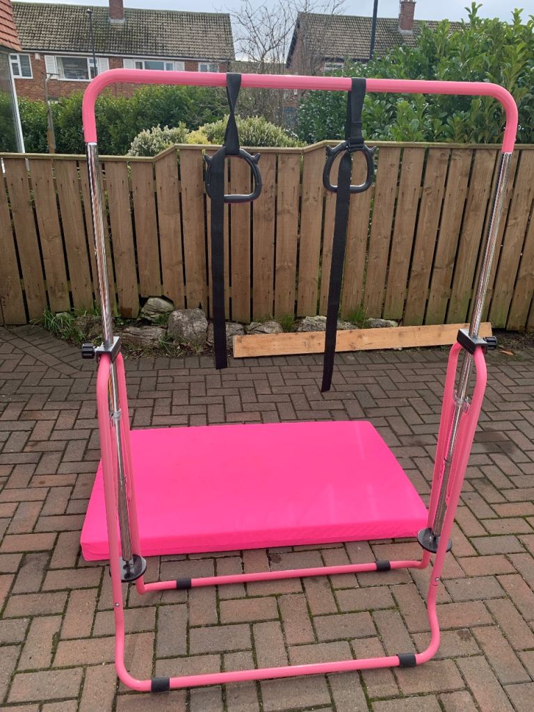 Pink gymnastics bar and mat 
