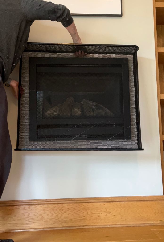 Custom made black metal wall fire guard with hooks for inbuilt wall fire