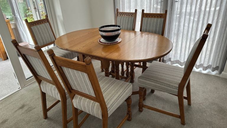 Solid oak six seater drop leaf dining room suite.