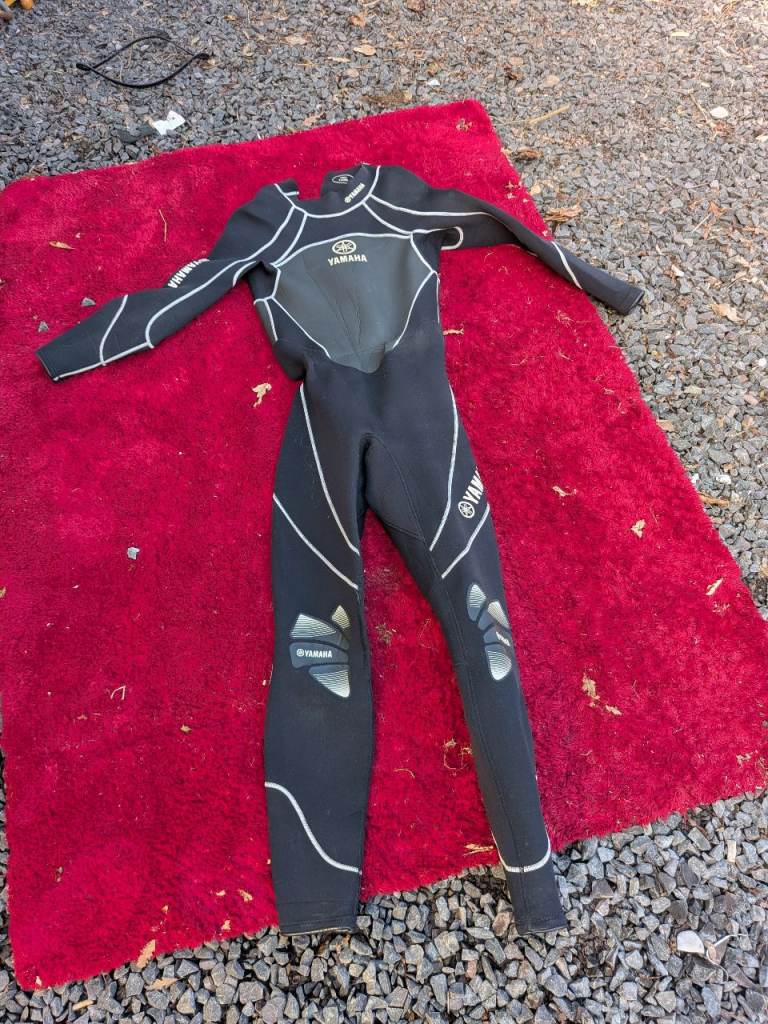 Various drysuits wetsuits and buoyancy aids