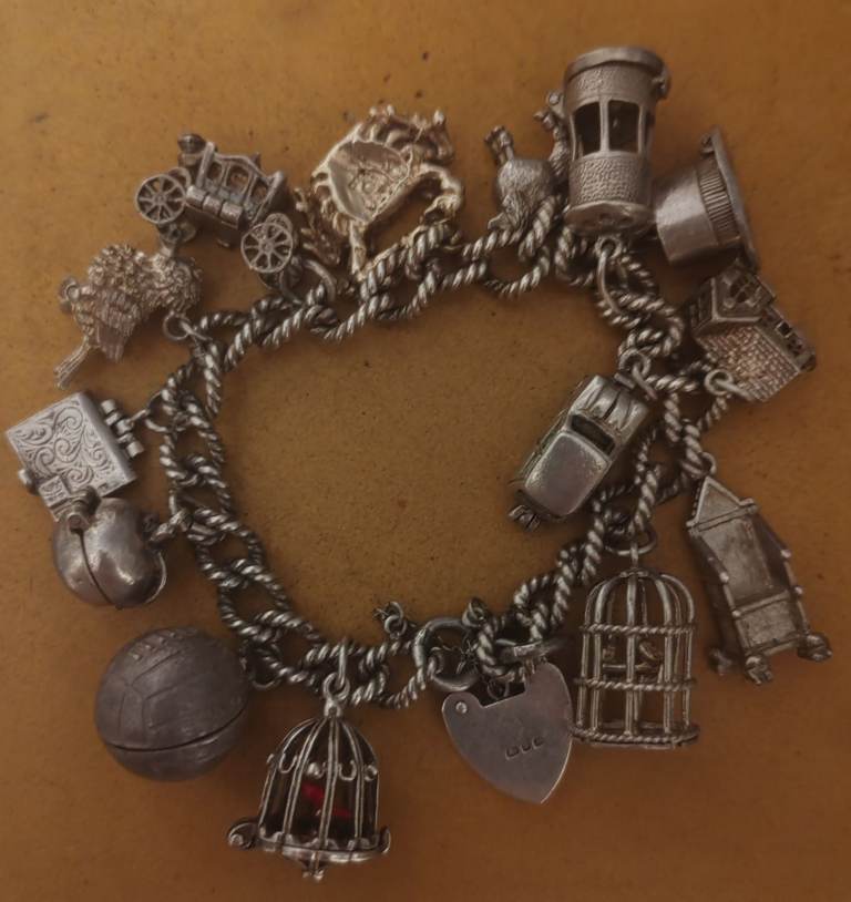 Silver charm bracelet with 14 charms 