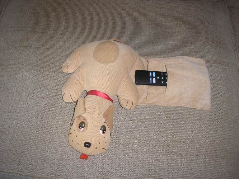 Dog to store remote controls, fits over chair arm. From pet & smoke free home