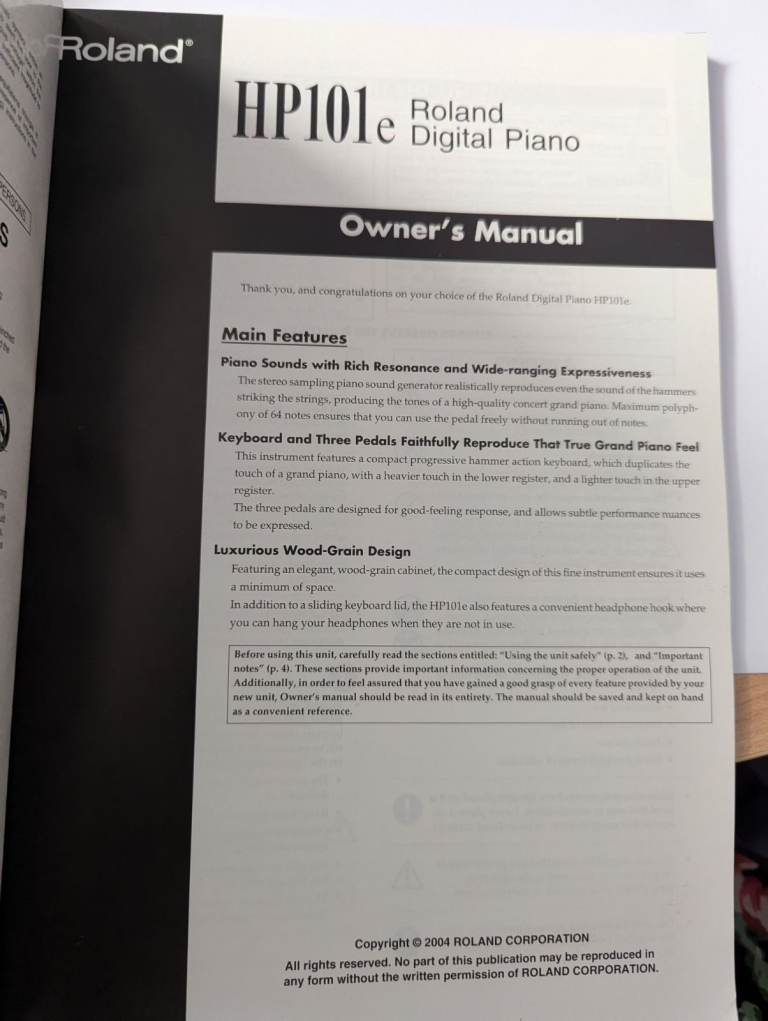 Roland HP101e digital piano on stand with pedal