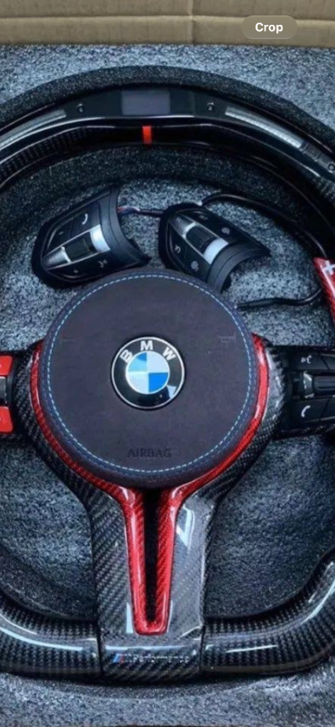 BMW M sport style steering wheel with red lining and also perforated grips