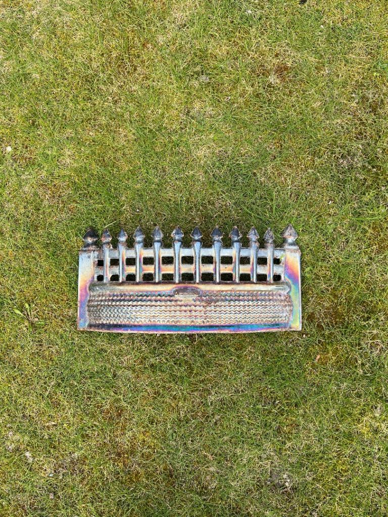 Antique iridescent cast iron fireplace fret