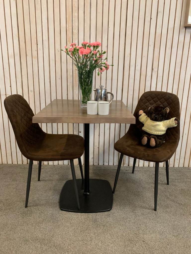 Bistro Dining Table with two Chairs, featuring Square Bown Faux-Suede Seats .
