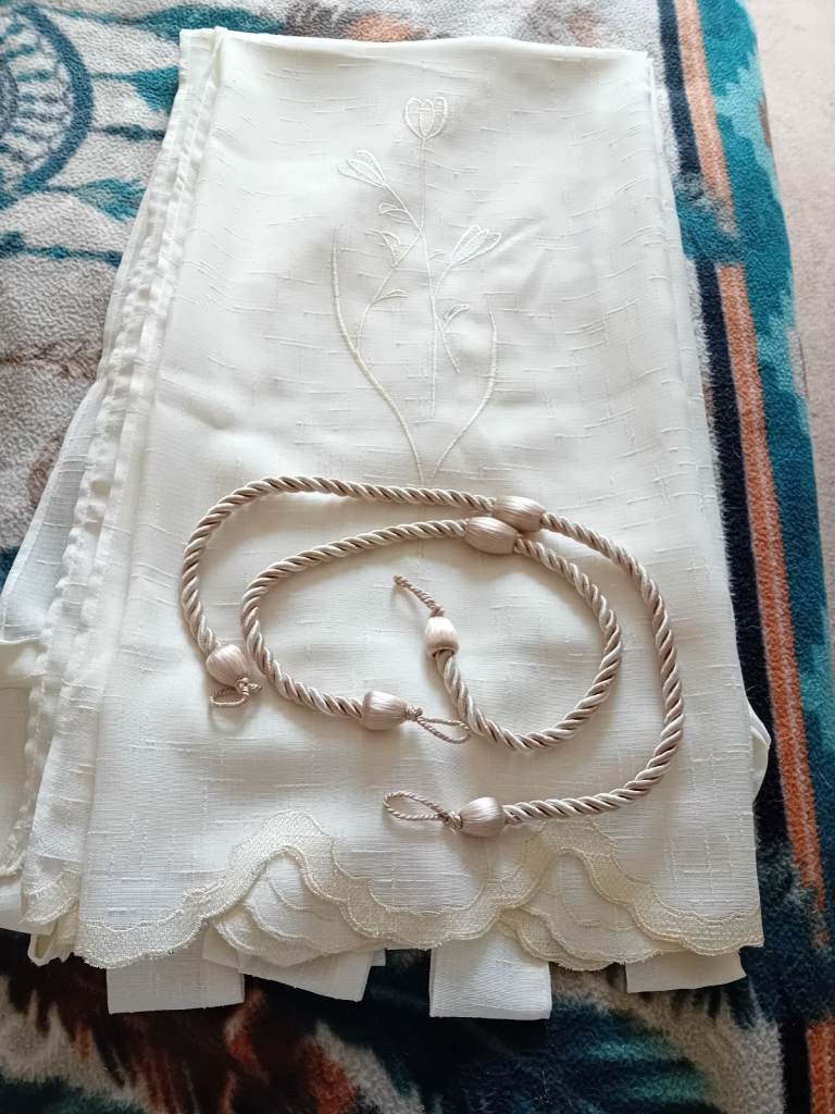 Cream voille curtains pair with tie - backs